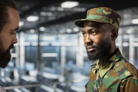 Army operators in server hub using device to run drone control software Stock Photos