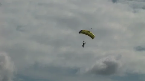 Army parachuting into a field for display Stock Footage 40802397