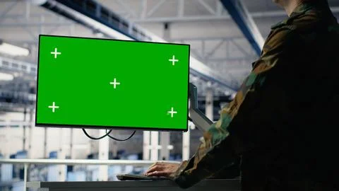 Army programmer in server hub uses AI application on green screen mockup PC Stock Photos