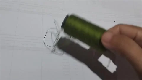 Army Sewing Thread Spool Lying on White Background Stock Footage 296978593