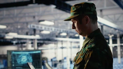Army software developer in server hub uses artificial intelligence app on laptop Stock Footage 314803343