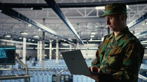 Army software developer in server hub uses artificial intelligence app on laptop Stock Footage 314804711
