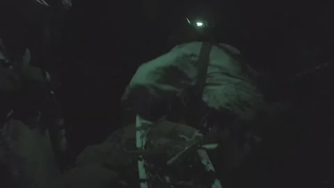 Army soldier off-loading sled from CH-47 Chinook at night Stock Footage 265143084