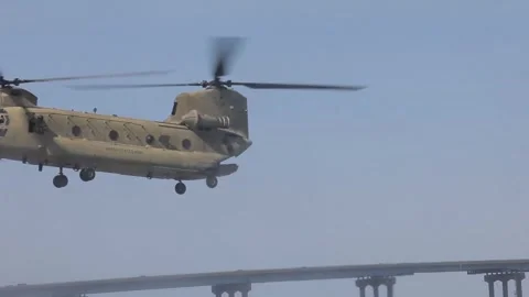 Army soldier looking out from CH-47 Chinook during flight Stock Footage 283728769
