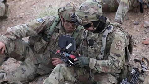 Army soldier operating handlheld computer tablet during military exercise Stock Footage 268823587