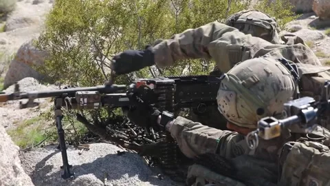 Army soldier reloading weapon in desert Stock Footage 268823965