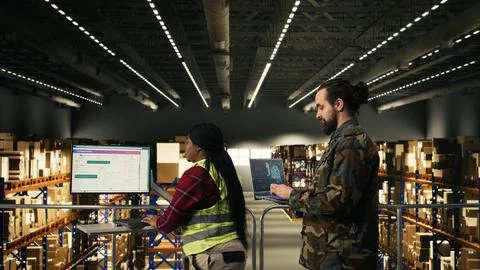 Army soldier using AI-powered tools in logistics hub at military base Stock Photos