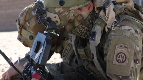 Army soldier utilizing handlheld computer tablet during military exercise Stock Footage 268824177