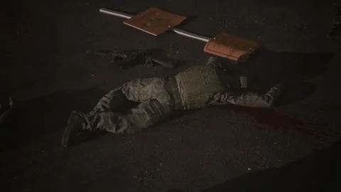 Army soldier wounded on the ground asking for help in street war Stock-Footage 289199638