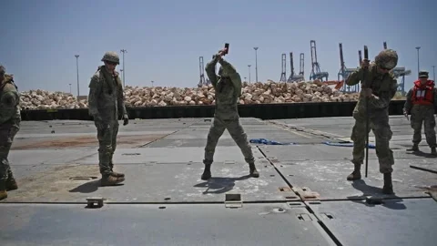 Army soldiers assembling floating pier to support delivery of humanitarian aid Stock Footage 297066609