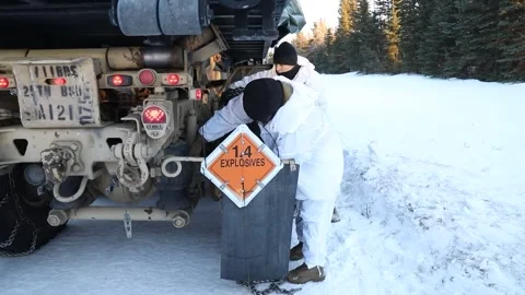 Army soldiers fitting snow chains to military truck Stock Footage 260312734