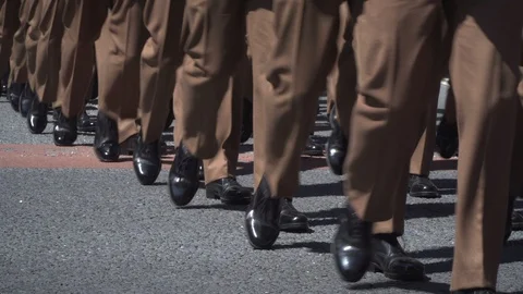 Army Soldiers parade through the streets in homecoming parade. Brown uniform. Stock Footage