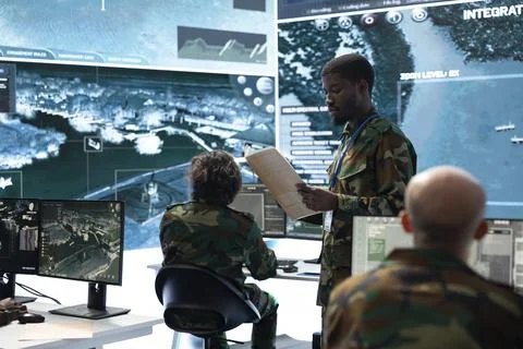 Army specialist reading folder documents in command center Stock Photos