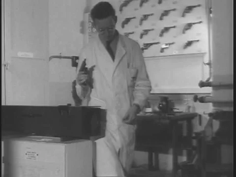 An army technician tests a firearm to identify a suspect's gun at a crime Stock Footage 75414403