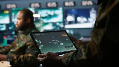 Army telecommunication systems operator using satellite software on tablet Stock Photos