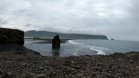 Arnardrangur basalt stack on Reynisfjara black sand beach, Iceland Stock Footage 334679720
