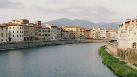 Arno River and Ponte di Mezzo, Lungarno Boulevard at sunset in Pisa Stock Footage 265408944