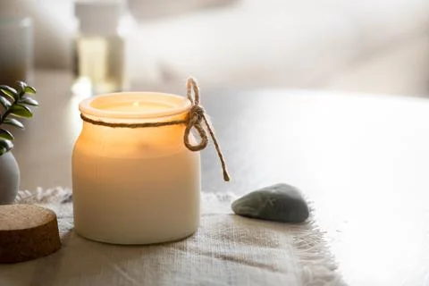 Aroma candle on table in badroom, decor elements, cozy home and relax concept Stock Photos