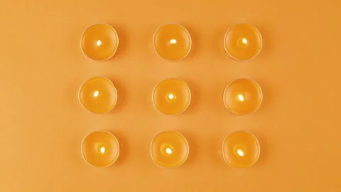 Aroma candles on orange background close up top view, zoom. Summer bright Stock Footage 243668509