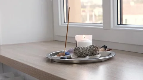 Aroma diffuser, burning candles on a metal tray on the windowsill Video stock 268799347