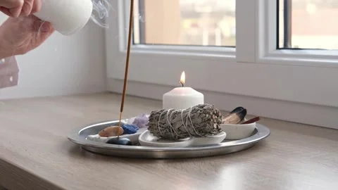 Aroma diffuser, burning candles on a metal tray on the windowsill Video stock 268799949
