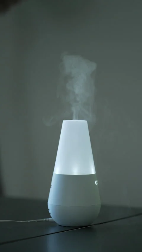 Aroma diffuser at home table in Vertical Video Stock Footage 229279640