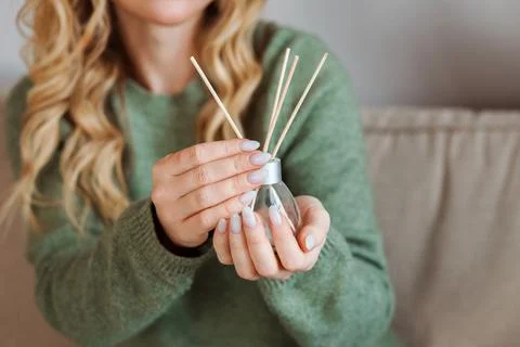 Aroma diffuser for home in the woman's hands with nude manicure. Stock Photos
