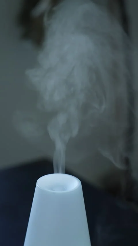 Aroma diffuser with steam at home table in Vertical Video Video stock 229279962