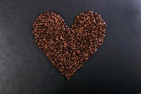 Aroma roasted coffee beans on rustic tabletop, brown banner background, shape Stock Photos