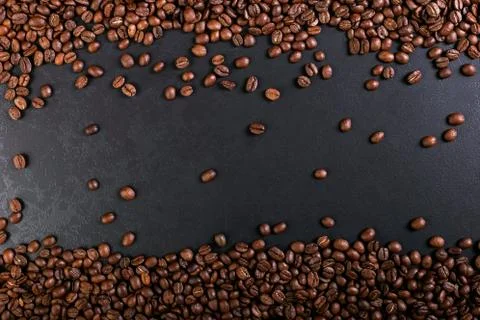 Aroma roasted coffee beans on rustic tabletop, brown banner background. Stock Photos