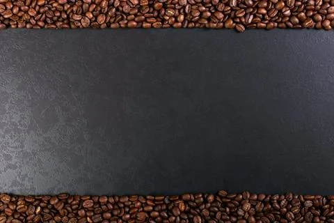 Aroma roasted coffee beans on rustic tabletop, brown banner background. Stock Photos