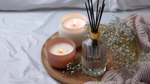 Aroma scented reed diffuser glass is on the tray with scented candle Stock Footage 262092173