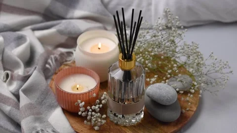Aroma scented reed diffuser glass is on the tray with scented candle Stock Footage 262623482