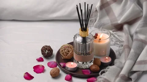 Aroma scented reed diffuser glass is on the tray with scented candle Stock Footage 262623582