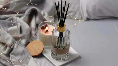 Aroma scented reed diffuser glass is on the tray with scented candle Stock Footage 262952365