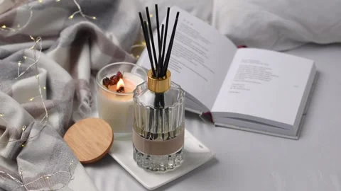 Aroma scented reed diffuser glass is on the tray with scented candle Stock Footage 263014023