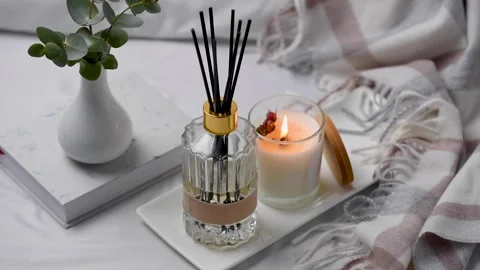 Aroma scented reed diffuser glass is on the tray with scented candle Stock Footage 263099860