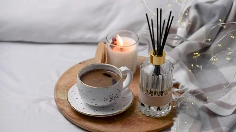 Aroma scented reed diffuser glass is on the tray with scented candle Stock Footage 263100094