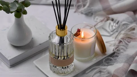 Aroma scented reed diffuser glass is on the tray with scented candle Stock Footage 263180787