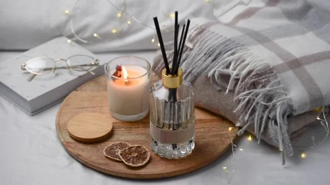 Aroma scented reed diffuser glass is on the tray with scented candle Stock Footage 263180878
