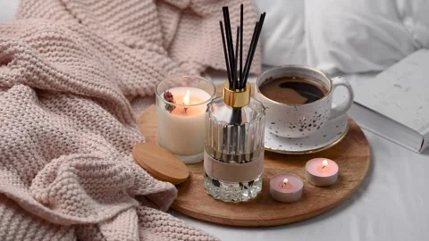 Aroma scented reed diffuser glass is on the tray with scented candle Stock Footage 263290244