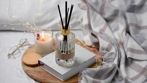 Aroma scented reed diffuser glass is on the tray with scented candle Stock Footage 263840622
