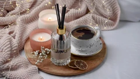 Aroma scented reed diffuser glass is on the tray with scented candle Stock Footage 263840660