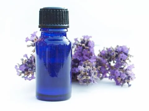Aromatherapy bottle close-up in front of Lavender flowers Stock Photos