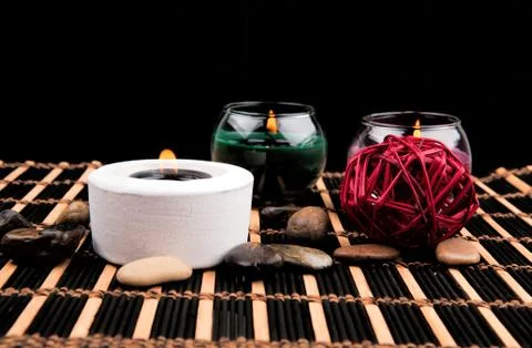 Aromatherapy. Candles and spa objects on black background Stock Photos