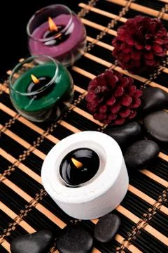 Aromatherapy. Candles and spa objects on black background Stock Photos