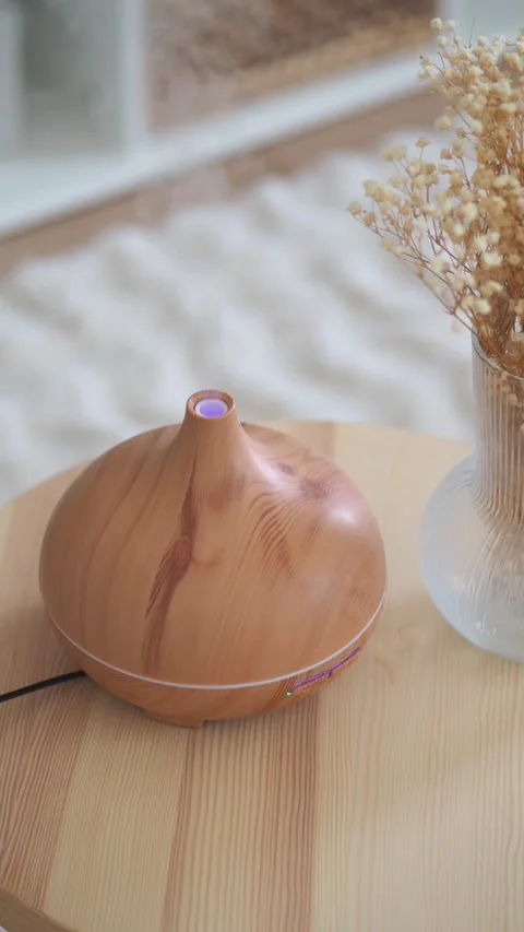 Aromatherapy device on a wooden table with flowers Stock Footage 331620315