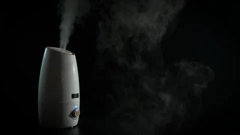 Aromatherapy with diffuser against black background. Video stock 283500242