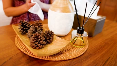 Aromatherapy Diffuser and Reed Sticks with Pine Cones on Wooden Tray Stock Footage 332887085