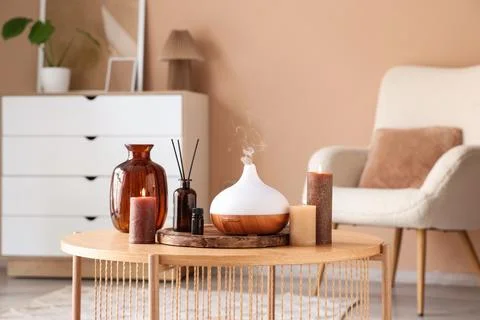 Aromatherapy diffuser with essential oil, reed diffuser, and lit candles on a Stock Photos
